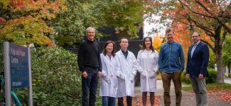 UBC Researchers pose with a scenic fall background