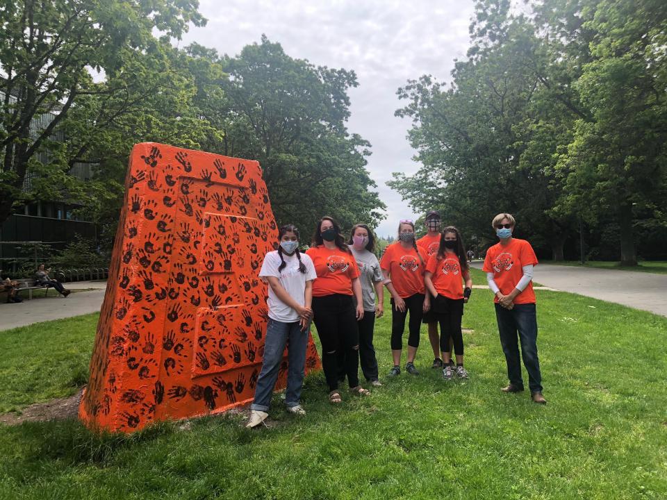 Students, faculty and staff applied 215 handprints on the cairn in honour of the 215 Indigenous children.