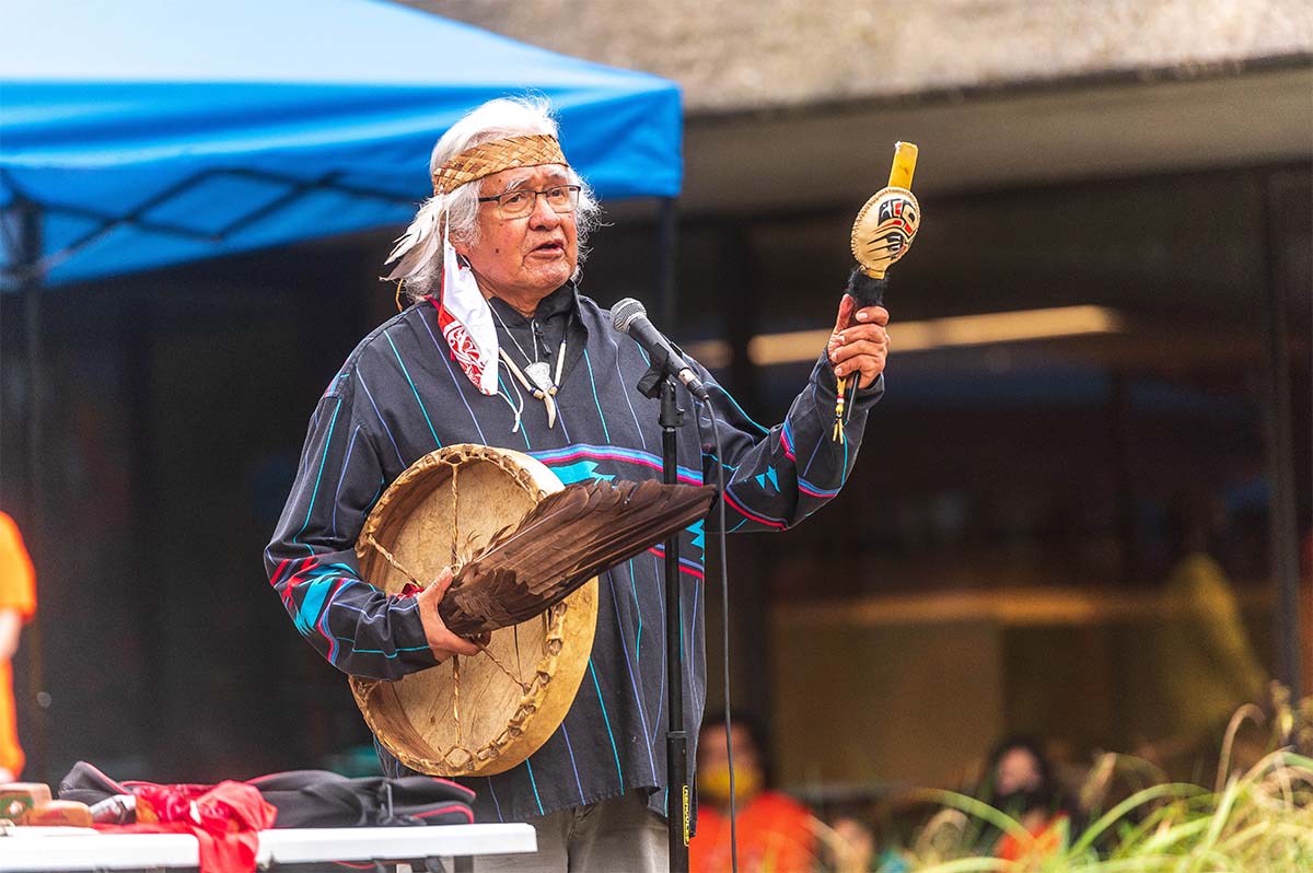 Elder Seis'lom addresses a crowd outside the Indian Residential School History and Dialogue Center on National Day for Truth and Reconciliation