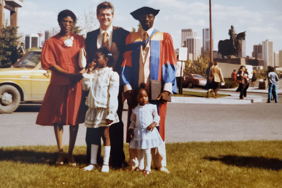 Dr. Gabriele Ogundele and his young family pose for the camera, following a University graduation.
