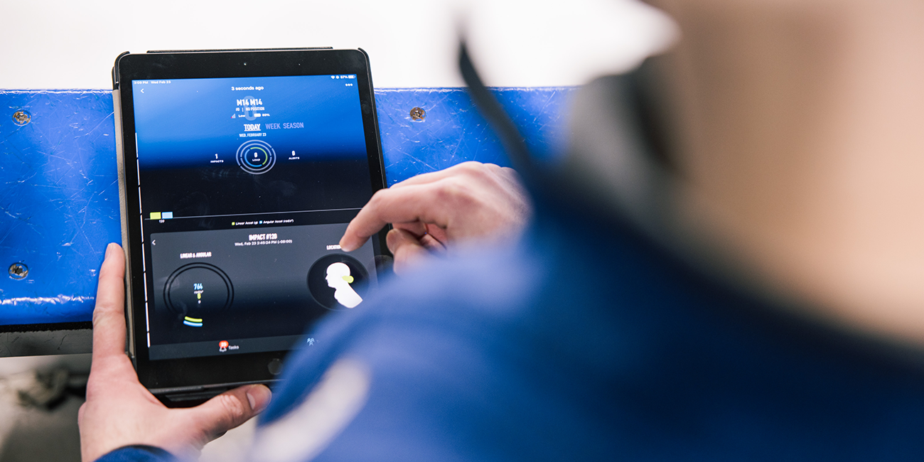 An iPad displays incoming impact data from a high-tech mouthguard which is captured in real-time via bluetooth