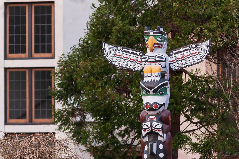 totem pole with building in the background