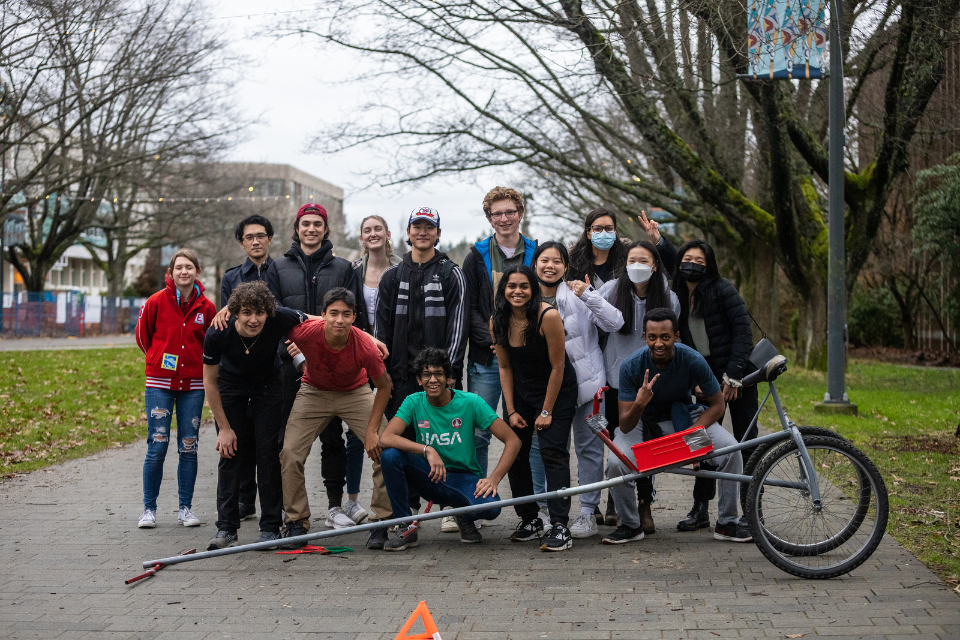 Mayank and his Integrated Engineering team, taking a photo with their chariot on Main Mall
