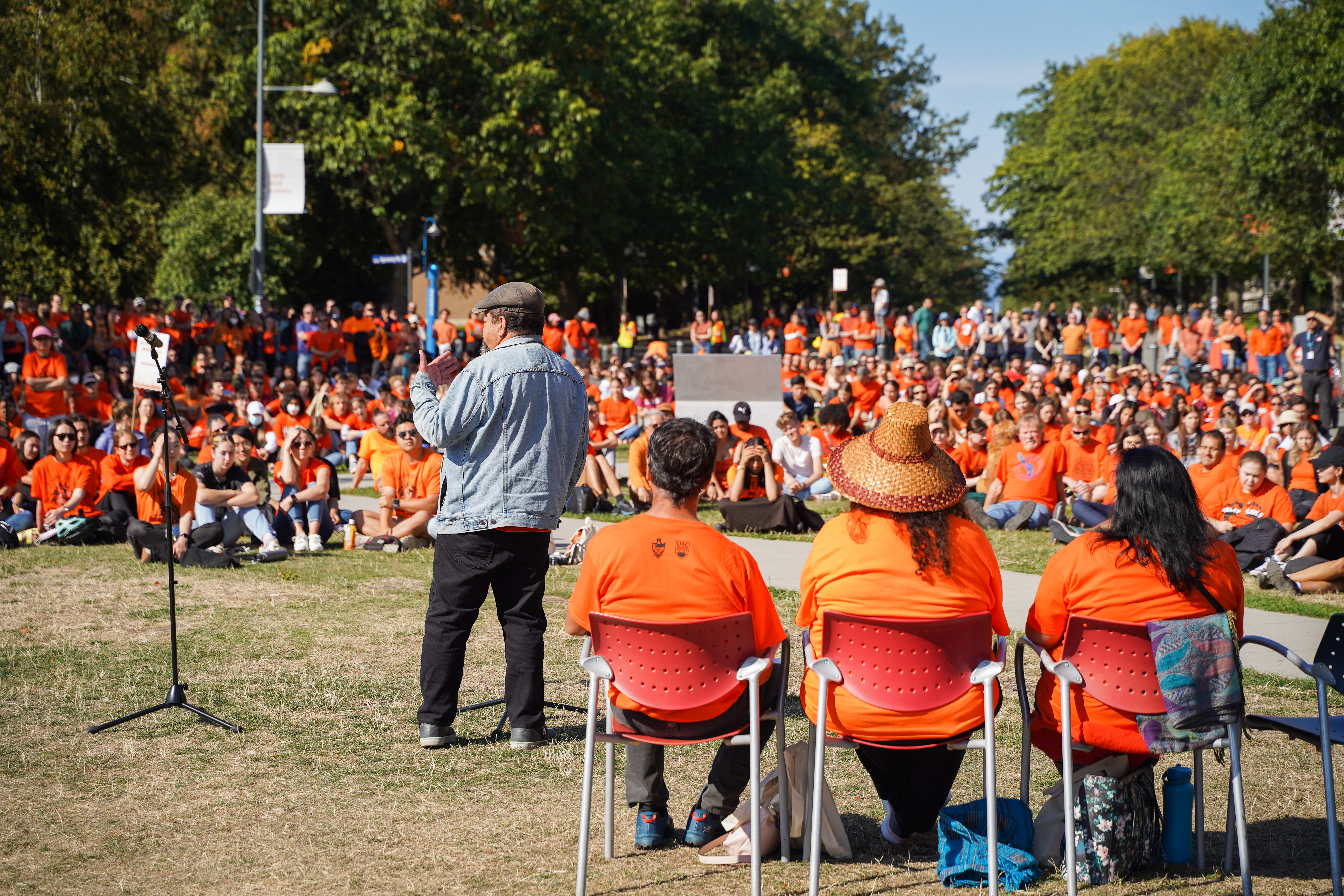 Elder John Jones addresses the crowd at the reconciliation pole.