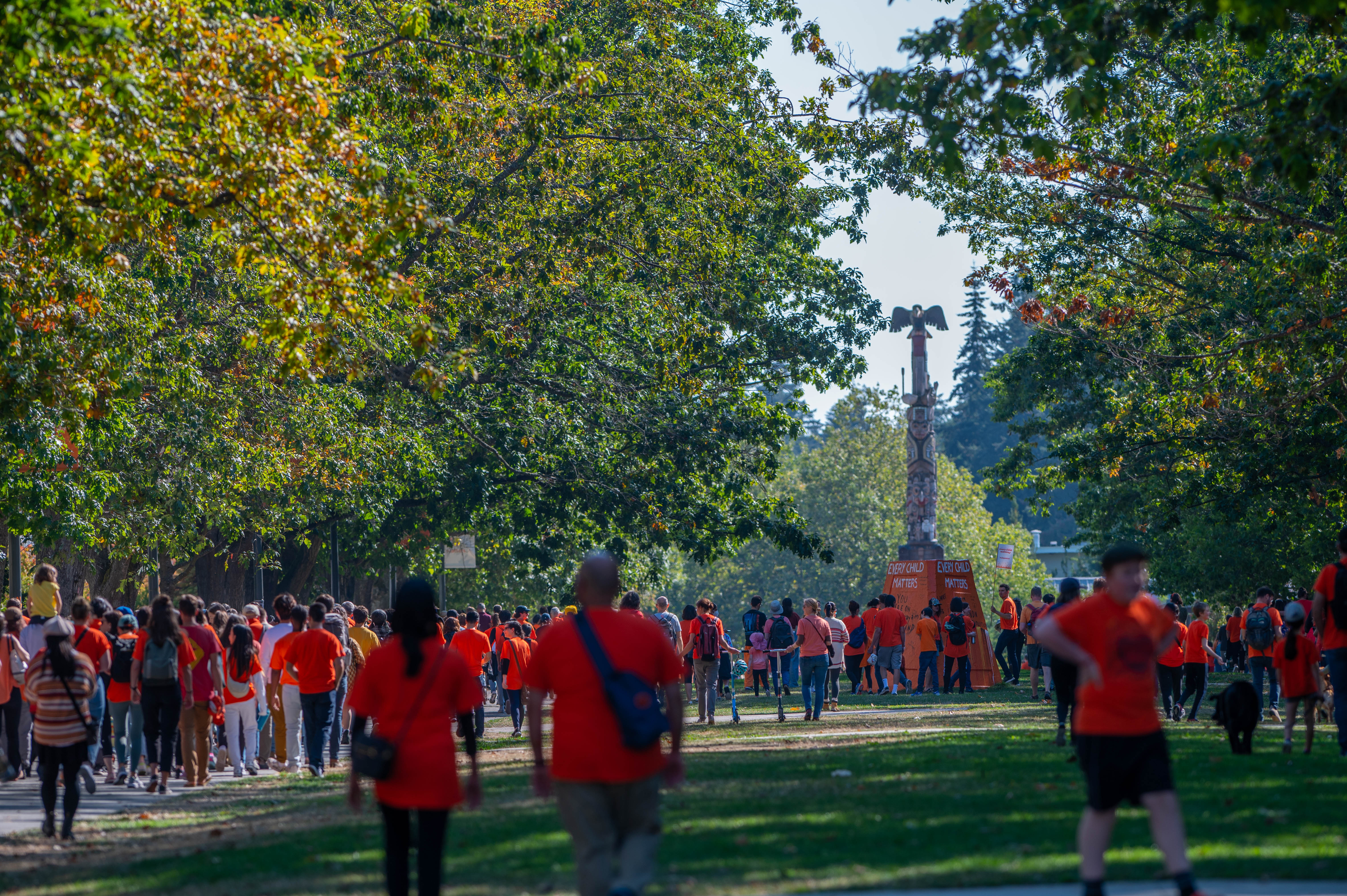 Participants march down Main Mall towards the reconciliation pole.