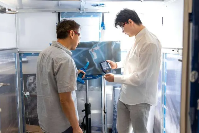 Dr. Sunny Li instructs a student on the ART device.