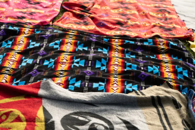 Five different patterned blankets laid out