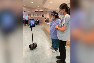 Medical professionals observe a new telepresence robot meant to help long-term-care residents stay connected.