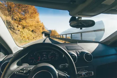 Car steering wheel with mountain view from the windshield
