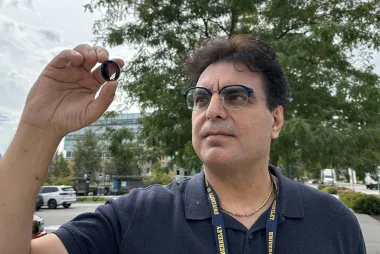 Dr. Hadi Mohammadi holds up a mechanical heart valve
