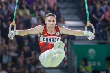 Zack Eberwein on the rings competing for Canada