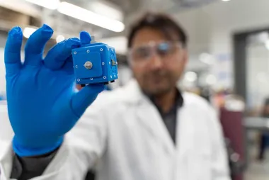 Researcher holding a new smart battery.