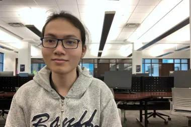 Andrew, smiling while working in the computer labs