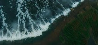  Aerial view of waves crashing onto shore