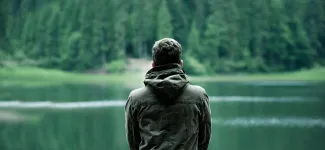 Man looking at lake