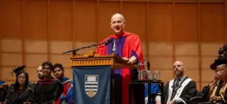 Engineering alum Erik Lindholm gives a speech at grad