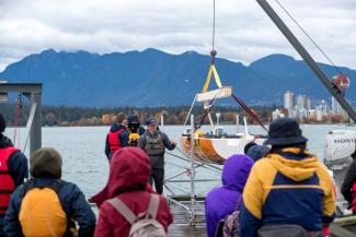 UBC Sailbot design team members prepare to lower Raye into the water for one of her first in water tests