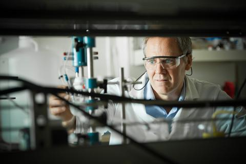 David Wilkinson looking at a machine in a lab