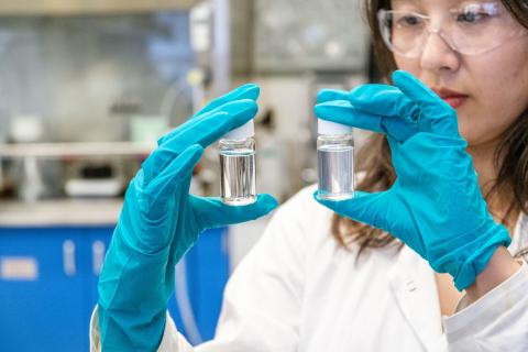 BPI postdoctoral researcher Dr. Tianyu Guo holds two vials of water.