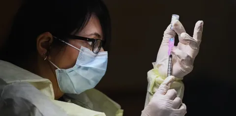 Woman holding vaccine