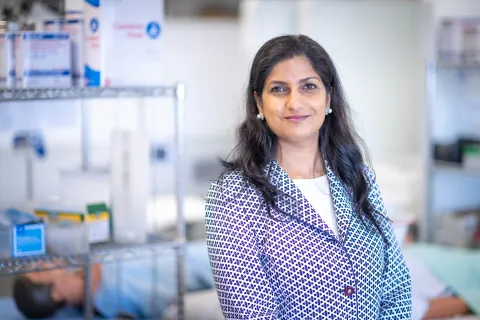 A photo of Rubee Dev in a laboratory