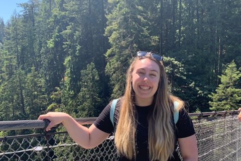 Meghan smiling in front of botanical forest